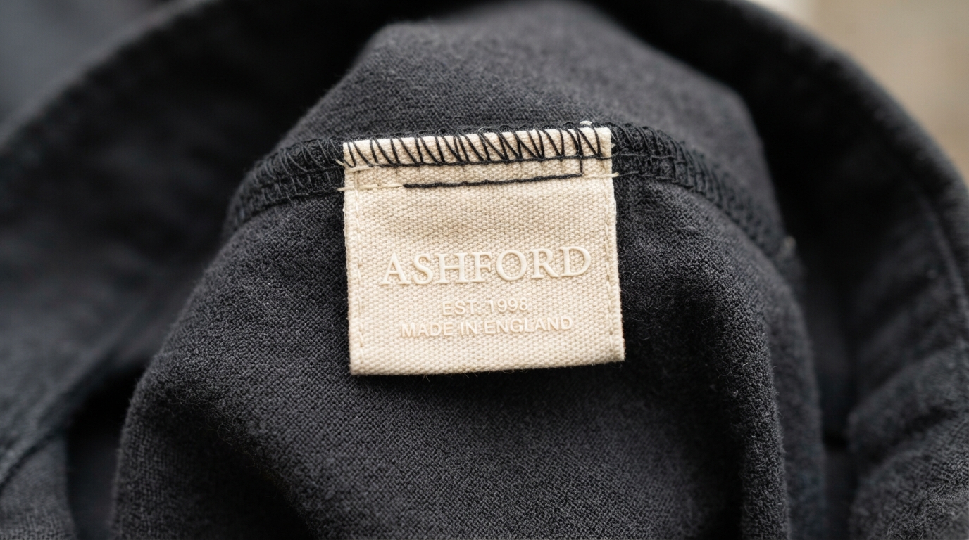 Woven care label sewn inside garment with brand wordmark